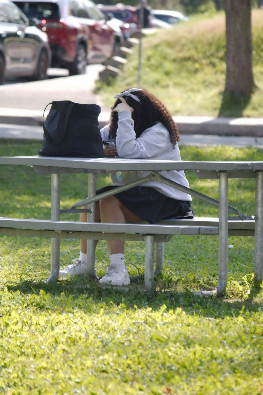 A woman sitting on a bench in a park