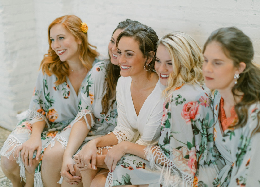 Five women in floral robes smiling together